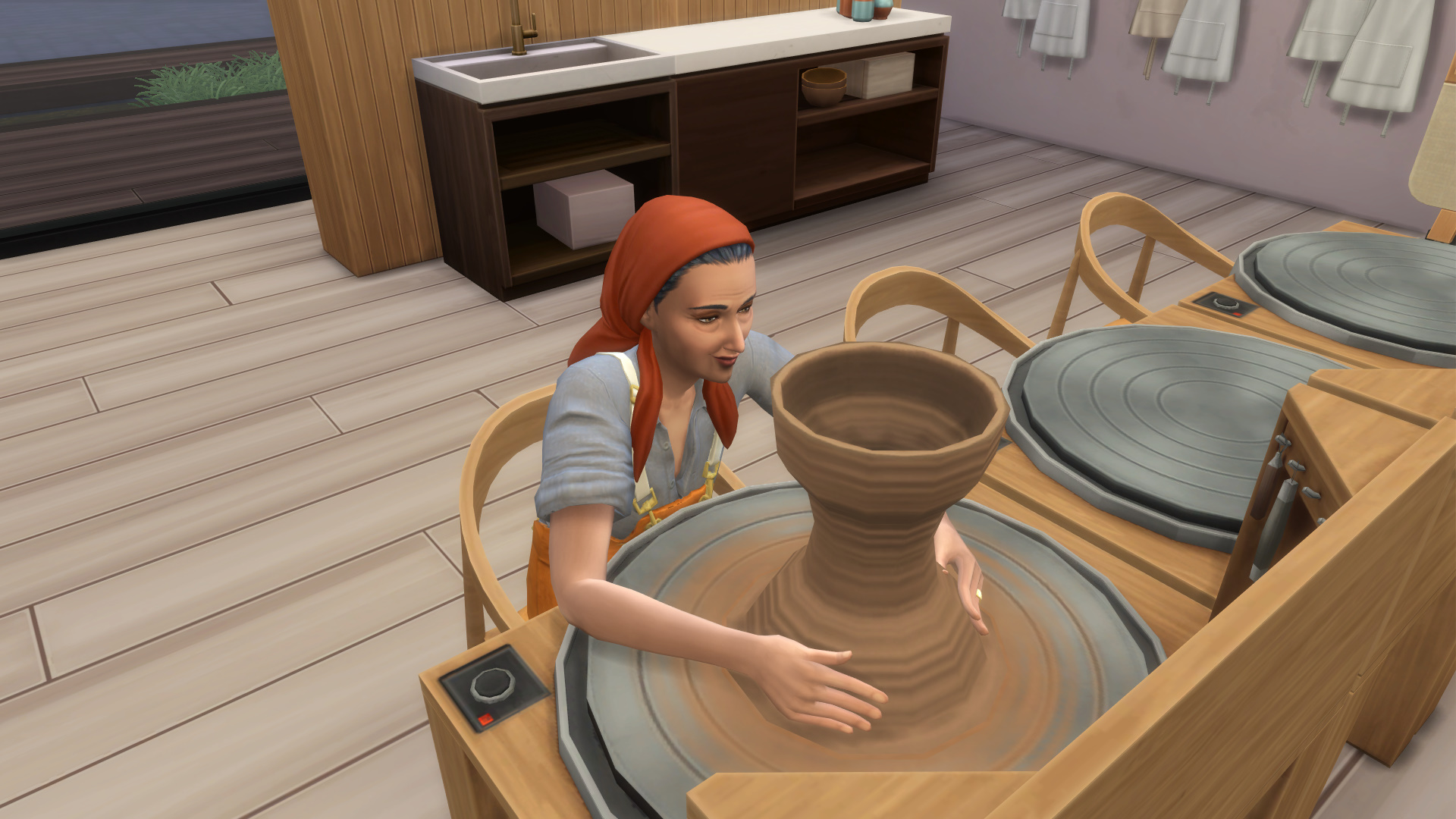 Sim shaping a tall clay vase on a pottery wheel in The Sims 4