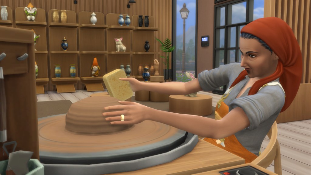 Sim smoothing clay on a pottery wheel using a sponge in The Sims 4