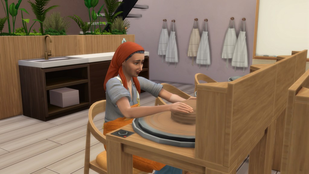 Sim using a pottery wheel to shape clay in The Sims 4